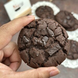 a hand holding a chocolate chip cookie | Pies & Quiches (Eggless) - Cookies Baking Class in Mumbai